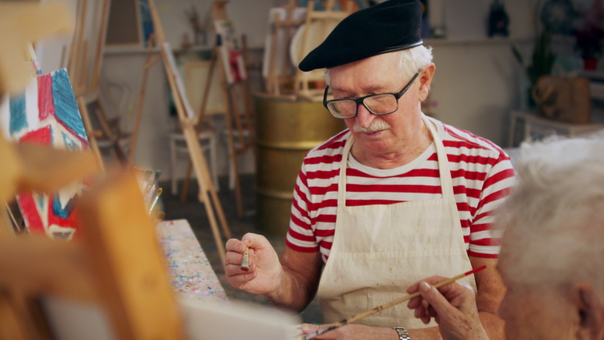 Senior couple painting together in artist atelier.