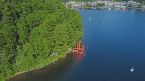 Lake Ashinoko in summer, above Hakone Shrine in clear weather, drone footage overlooking the Torii of Peace 4K slow motion