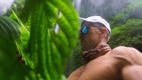 Active lifestyle people travel in tropical rainforest jungle and enjoy beautiful waterfall on nature background 4K