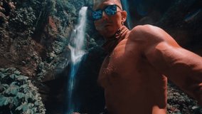 Active lifestyle travel people enjoy beautiful waterfall hidden in tropical rainforest jungle on nature background Slow motion video