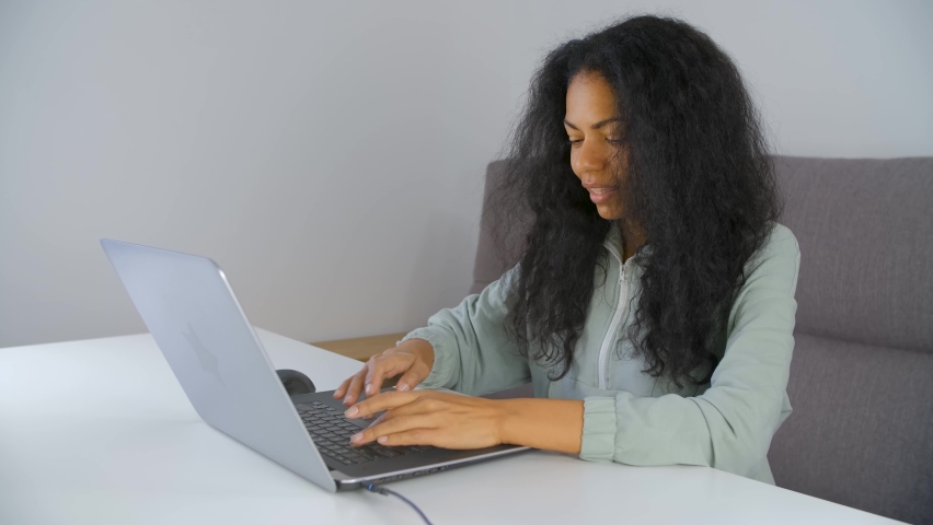 Black woman entrepreneur working on computer. Young adult african person typing text on modern laptop at home | Shutterstock HD Video #1094845117