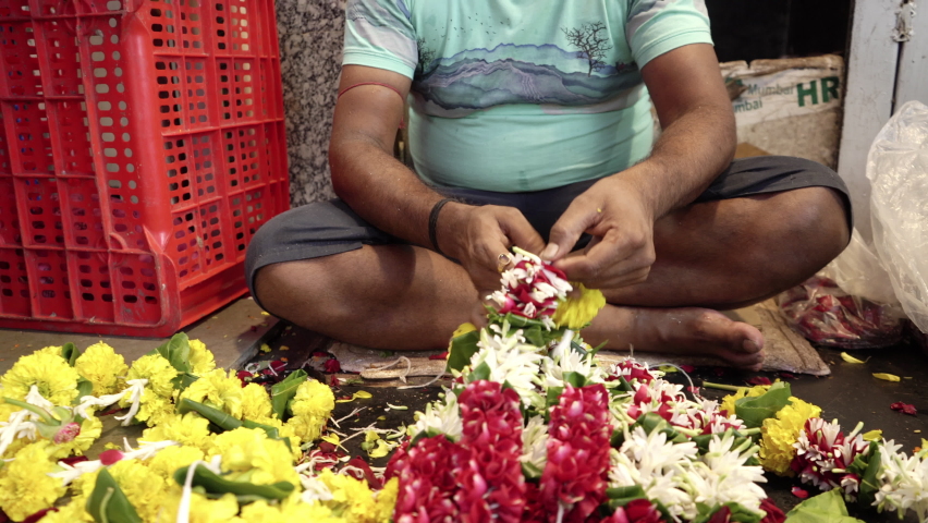 Closeup of a hand making flower garland, Mumbai, India Royalty-Free Stock Footage #1094845239