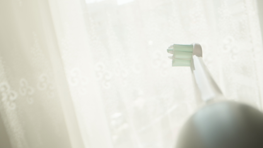 I put toothpaste on an electric brush, POV super close-up.