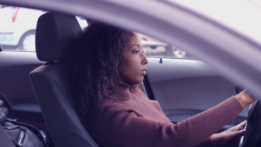 young beautiful woman in the car waits for someone impatient
