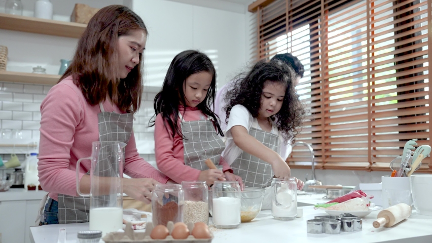 Happy family cooking together on kitchen.