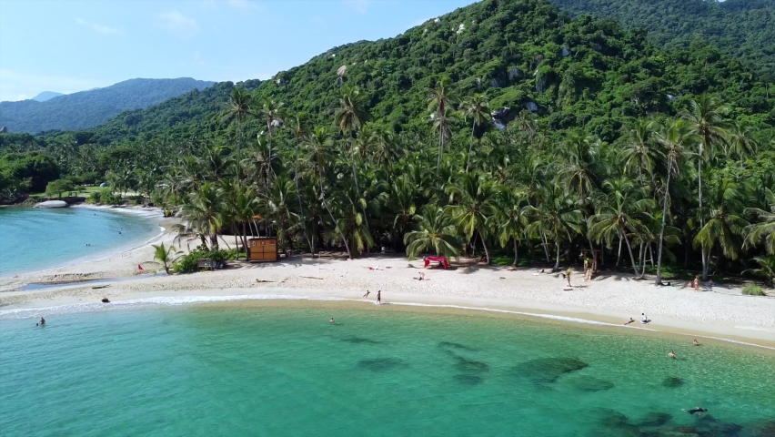 Santa Marta Colombia , Tayrona Natural Park Caribbean sea Cabo San Juan  - Drone aerial view of amazing  sand beach and  forest - Tourist attraction for relax and enjoy the paradise of the ocean sea  Royalty-Free Stock Footage #1094854451