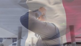 Animation of flag of france waving over caucasian man wearing face mask in city street. global health precautions during covid 19 pandemic concept digitally generated video.