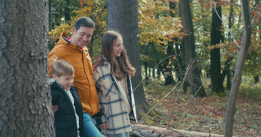 Happy family outdoors while spending his free time, Father and children are happy to walk park, Parents hold the child by the hands. Enjoy time together. Natural colors. | Shutterstock HD Video #1094866321