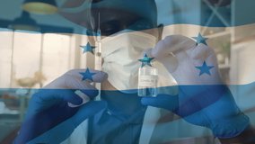 Animation of flag of honduras waving over doctor wearing face mask and holding vaccine. global medicine, healthcare services during covid 19 pandemic concept digitally generated video.