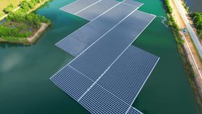 Drones are flying over solar cells on the pond, clean energy plants in low-lying areas. alternative renewable energy concept. electrical innovation. 4K
