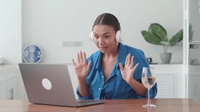 Caucasian adult woman in headphones calling on business. Video chat concept.