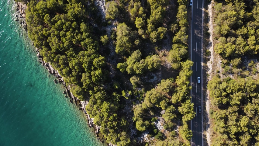 Aerial view of a road driving along the coast near Zadar, Croatia. Royalty-Free Stock Footage #1094880011