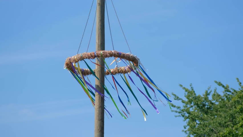 Traditional circle with ribbons on the pole develop in the wind. Maypole Set-Up, Customs With A Long Tradition, Germany. | Shutterstock HD Video #1094880261