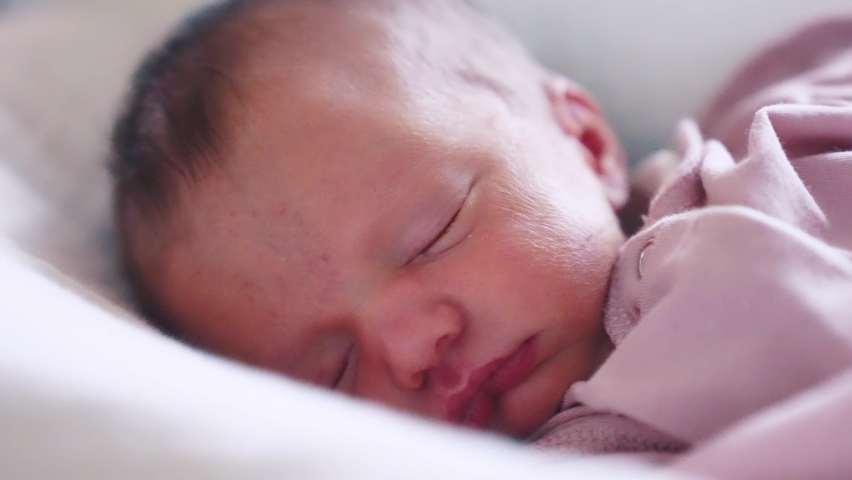 newborn baby sleeping. cute a brunette newborn baby sleeping in bed close up in maternity hospital bedroom. happy family lifestyle kid dream concept. cute newborn baby girl sleeping close up Royalty-Free Stock Footage #1094890183