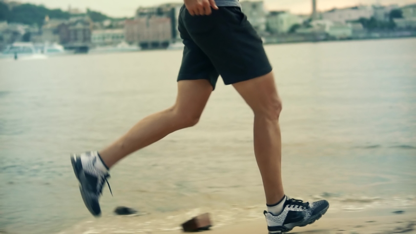 Runner Jog On Beach. Fitness Man Running. Empowered Athlete Jogging Exercise. Cardio Run Fitness Exercising. Aerobic Runner Running At Effort. Intensive Training Run Workout. Footwear Legs Running Jog Royalty-Free Stock Footage #1094897975
