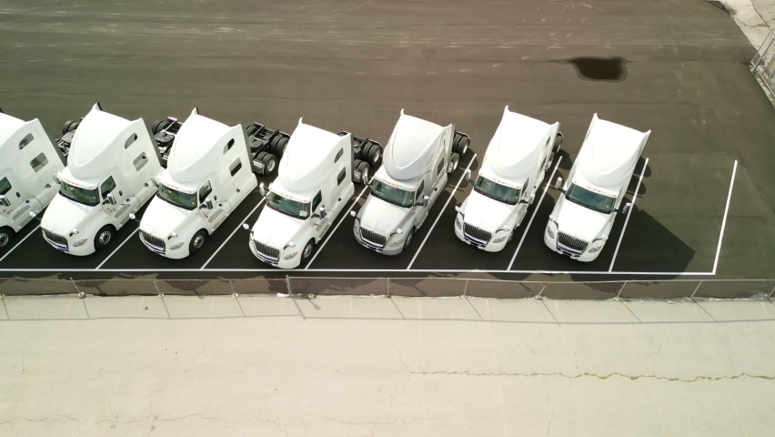 Aerial shot of trucks stand in the parking lot. Top view, move camera Royalty-Free Stock Footage #1094905793