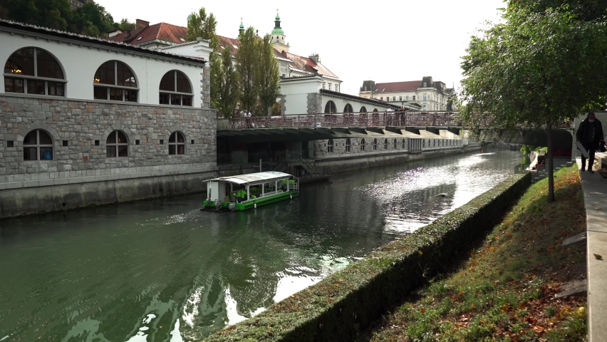 Butcher's Bridge in Ljubljana. Pedestrian bridge over the river Ljubljana in Ljubljana. Bridge of lovers in Ljubljana. Locks of lovers along the railing as a sign of love and fidelity to each other. Royalty-Free Stock Footage #1094910773