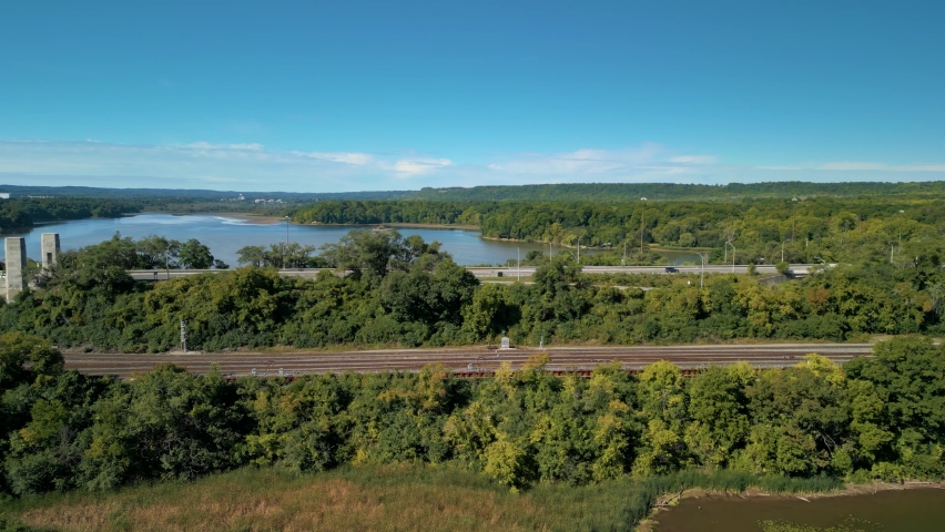 Aerial 4K video of McQuesten Bridge along with train tracks along the Burlington Bay coastline in Hamilton Ontario