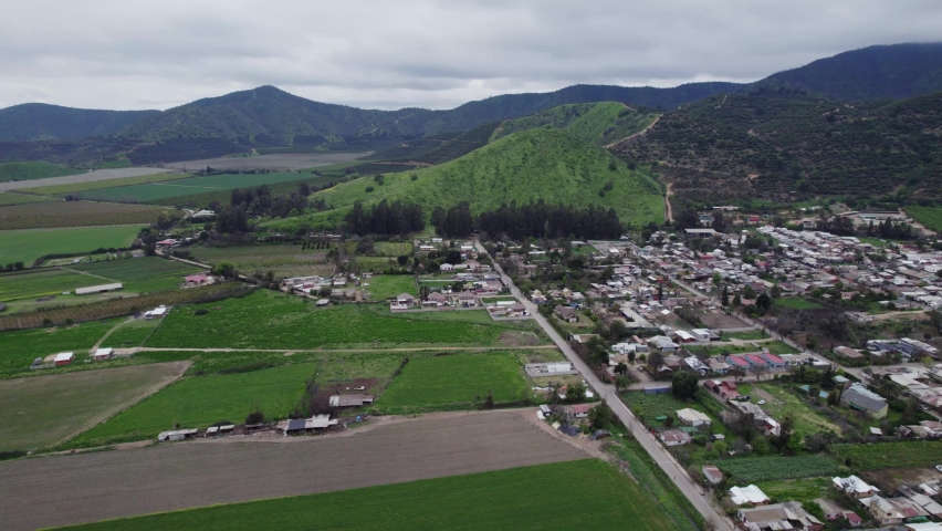 Pomaire Chilean Town On The Foothills Of Mountain With Green Field In Melipilla, Chile. - aerial