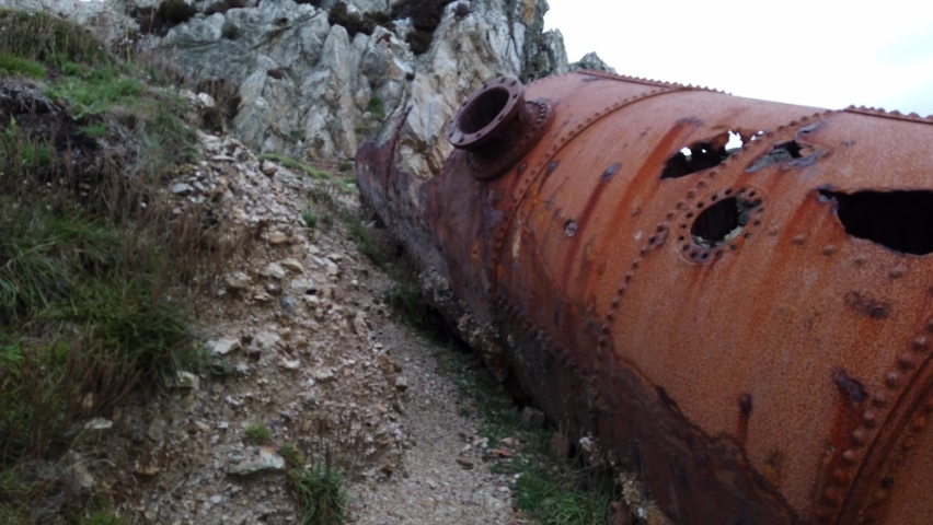Large industrial rusty tank container on abandoned Welsh Traeth Porth Wen brickwork factory