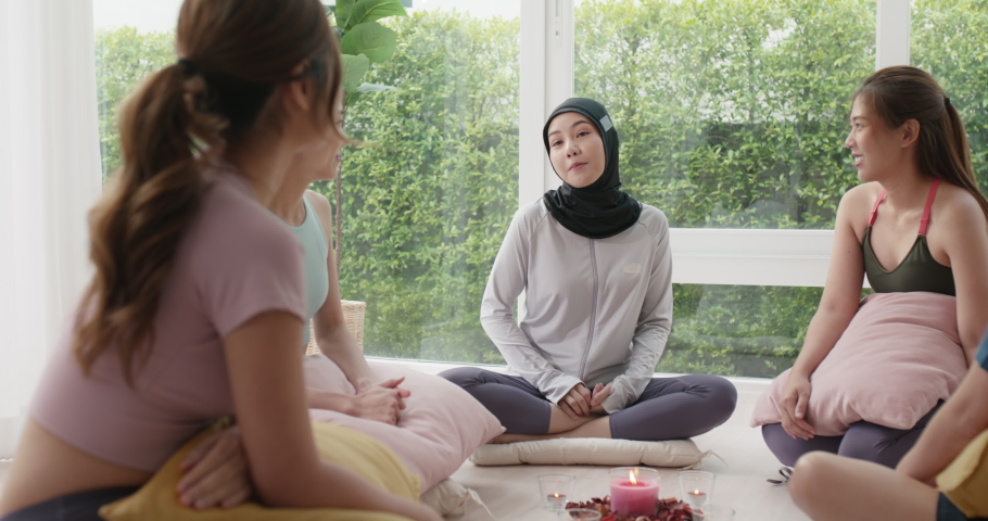 Gen Z asia people islam yoga coach girl in mental health care rehab center class fun laugh smile sit circle relax at workout club studio. Stress relief group talk young adult unity team life balance. Royalty-Free Stock Footage #1094915569