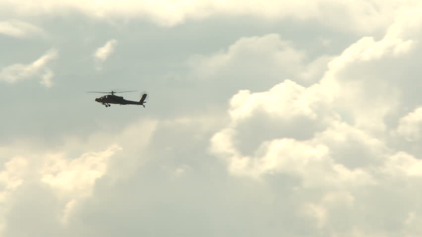 Apache Helicopter flyby on a cloudy sky