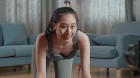 Young Asian Trainer Female Speaking To Camera Before Doing Cardio High Knees And Core Strengthening Exercises While Recording Teaching Exercise At Home

