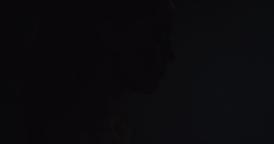 Creative, makeup and art with silhouette of woman in studio for design, beauty and abstract cosmetics on face. Paint, fantasy and light with young girl for art deco, designer and fashion shadows