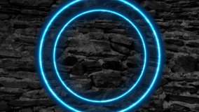Blue glowing neon circles on black grunge stone wall abstract background. Seamless looping motion design. Video animation Ultra HD 4K 3840x2160