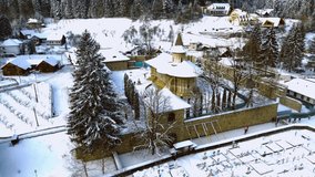 Aerial footage of medieval Voronet Monastery, located in Suceava county, Romania. Video was shot from a drone while flying backwards from the monastery, gaining altitude.