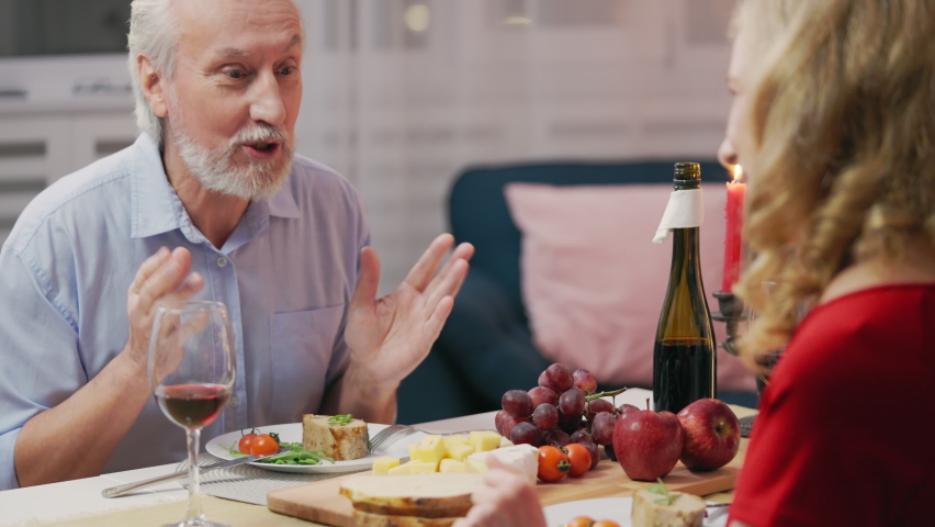 Happy man in his 50s communicating with girlfriend during romantic dinner, date | Shutterstock HD Video #1094926155
