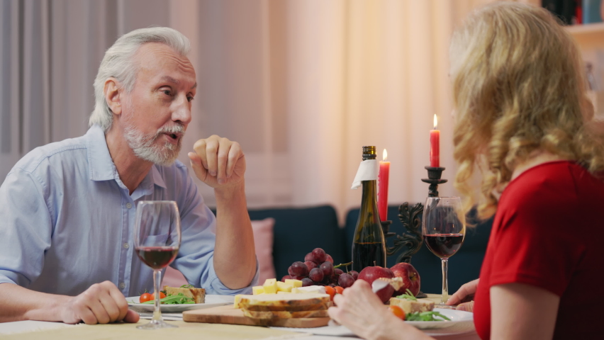 Senior husband talking with wife during romantic supper, trustful relationship | Shutterstock HD Video #1094926157