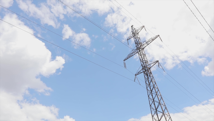 High voltage tower. Visualization of current in wires. High voltage tower concept. Electrical Transmission Tower against the blue sky. High Voltage Transmission Tower | Shutterstock HD Video #1094928547