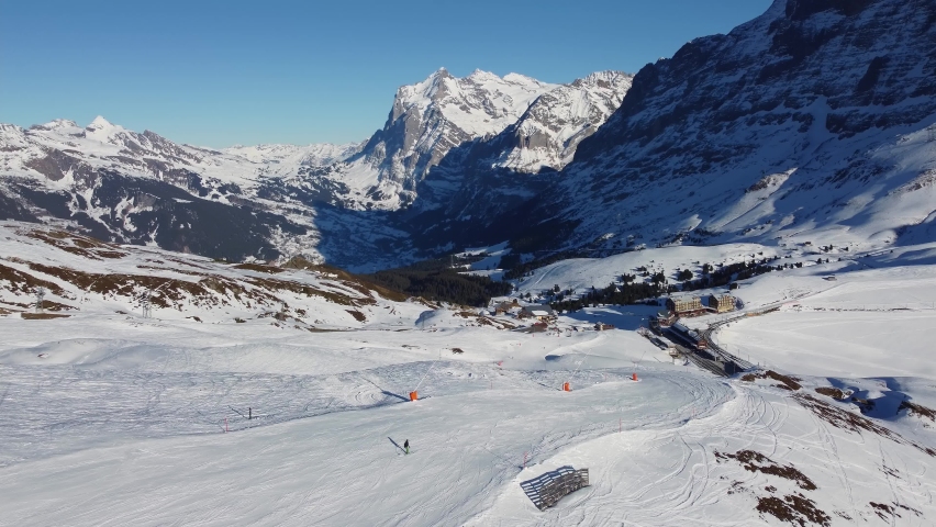 Grindelwald, Switzerland: Aerial drone footage of the Jungfrau region ski resort near the Kleine Scheidegg train station in the Berner Oberland alps near Interlaken in Switzerland Royalty-Free Stock Footage #1094933547