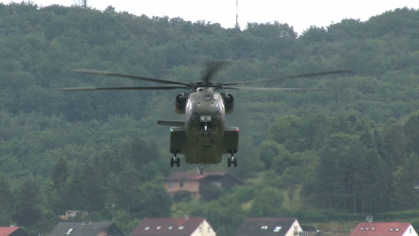 German bundeswehr helicopter landing on a field