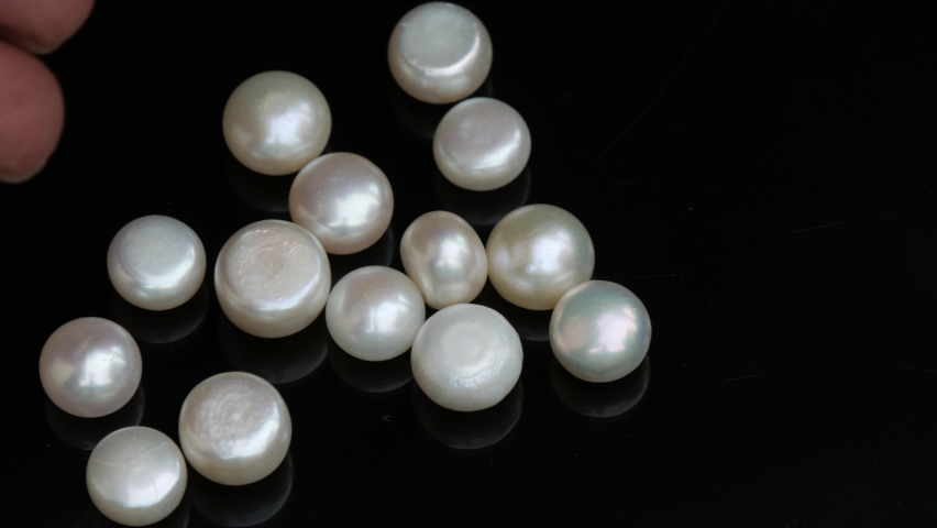 White pearls fall on black glass, gems business.precious stone | Shutterstock HD Video #1094935079