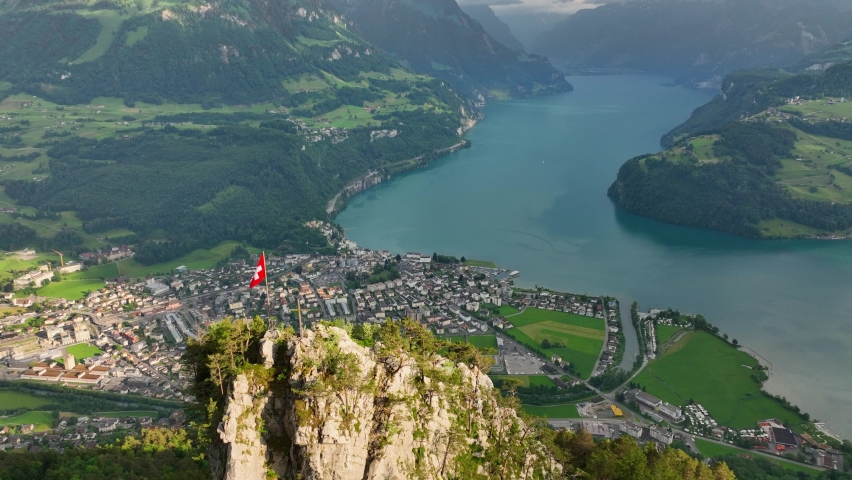 Swiss flag on a rock above beautiful Lucerne lake, panoramic aerial view of Luzern lake in Swiss Alps, amazing Swiss landscape  Royalty-Free Stock Footage #1094941573