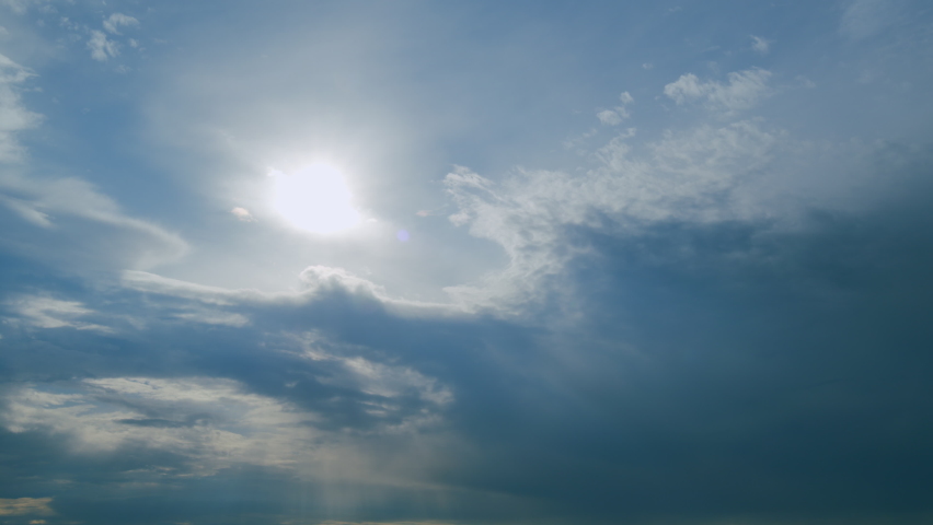 Solar energy concept of bright sun ray. Building clouds and sun rays breaking through cloud mass. Timelapse. | Shutterstock HD Video #1094944353