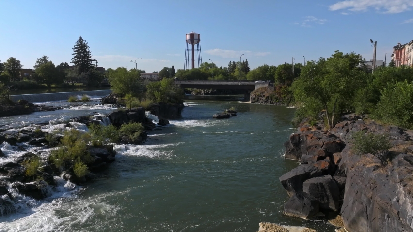 Aerial video of the waterfall in the city of Idaho Falls, ID USA. Large straight waterfall across the city in Idaho Falls.