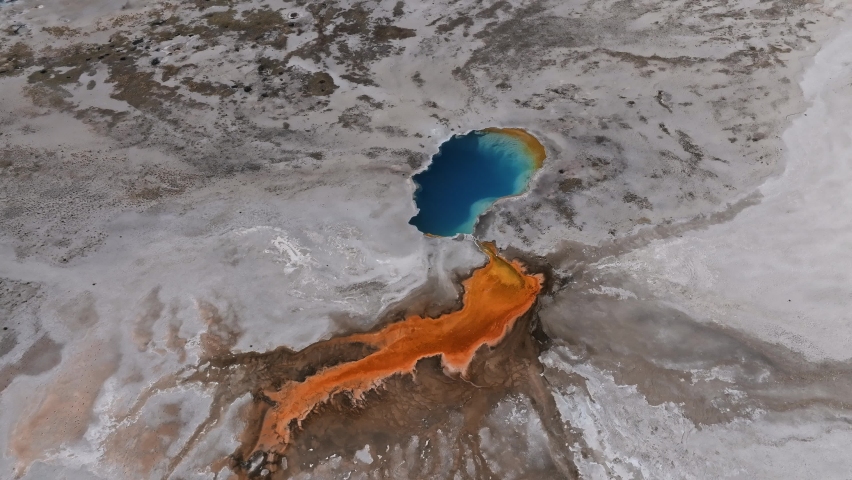 Aerial video of deep green orange geyser pool in the Yellowstone National Park. Scenic view over colorful Norris Geyser Basin in Yellowstone National Park