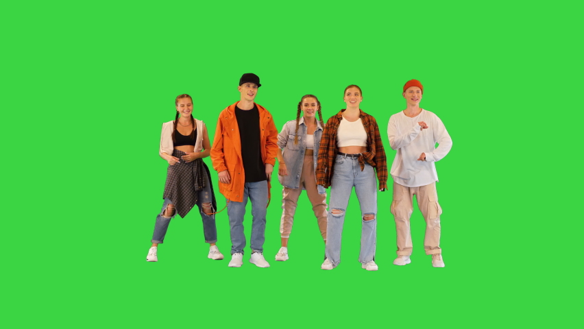 Group of dancers men and women are dancing slowly and then doing freeze move on a Green Screen, Chroma Key.