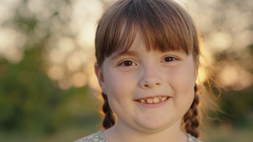 Kid smile. Happy child playing in summer park, baby face. Child smiles at camera. Happy little girl smiling in park, sunset. Cute baby face, girls outdoors close-up. Funny baby Girl or fantasy dreams | Shutterstock HD Video #1094955113