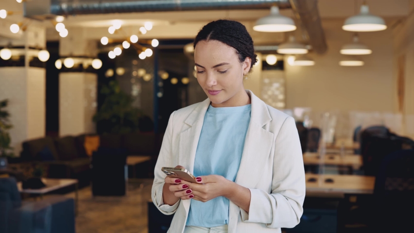 Mobile phone conversation. Busy positive stylish business lady, talking on a smartphone with a client, standing in the office, solving work issues, arranging a meeting, looking away, smiling friendly | Shutterstock HD Video #1094955157
