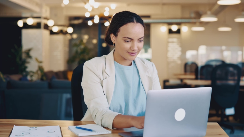 Calm relaxed mixed race female employee resting during work time, sits in modern office, puts hands behind head, feels satisfied by project done, job promotion, looking in laptop, smiling friendly | Shutterstock HD Video #1094955171