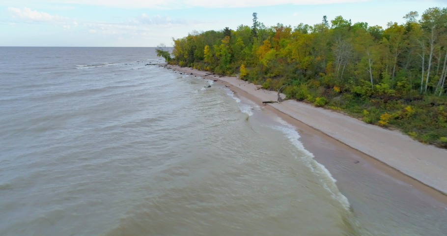 Lake Winnipeg shoreline flyover with changing fall colors