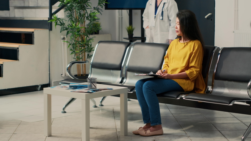 Senior doctor and asian woman doing consultation at healthcare clinic, talking about disease diagnosis and treatment. Doing checkup visit appointment in facility lobby, medical advice. | Shutterstock HD Video #1094968405