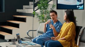 Female nurse and asian patient looking at futuristic hologram, using augmented reality and holographic image at consultation in waiting room. Analyzing high tech 3d ai at checkup. - Powered by Shutterstock - Get 15% off with code: PIKWIZARD15