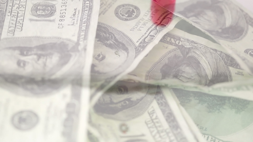 Animation of multiple banknotes over falling pills into water on the white bakcground. Medical staff during Covid-19 coronavirus pandemic concept.