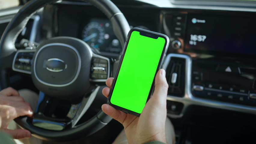 The green screen of the phone is chroma key in the car. Royalty-Free Stock Footage #1094973409