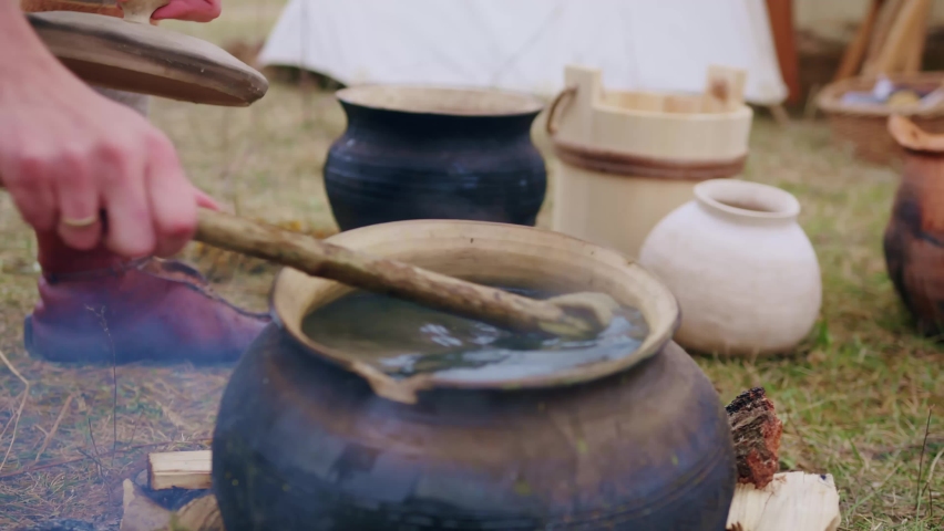 Close up of dyeing the textile in ceramic hot pot as it was done centuries ago | Shutterstock HD Video #1094975389